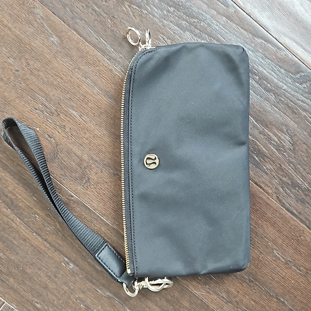 Lululemon Wristlet, Black with gold zipper, Nylon.  No stains or rips.  Zippers